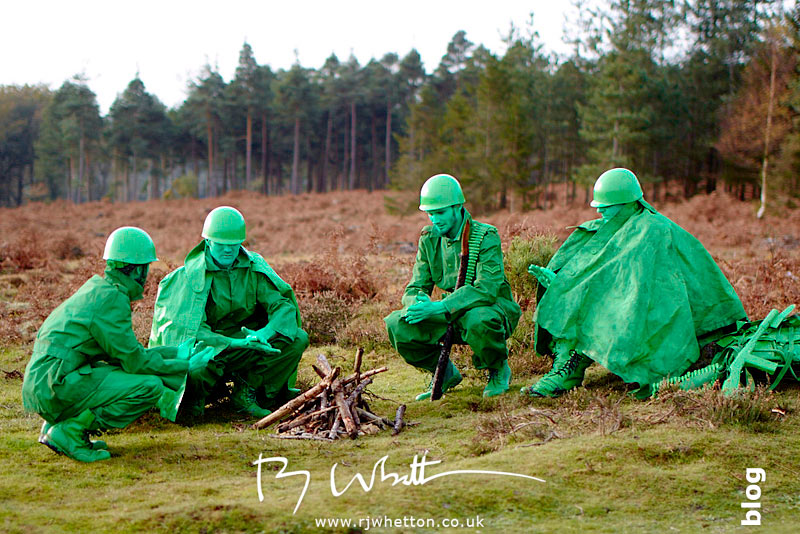 Green army men huddled around camp fire - Production Photography Dorset