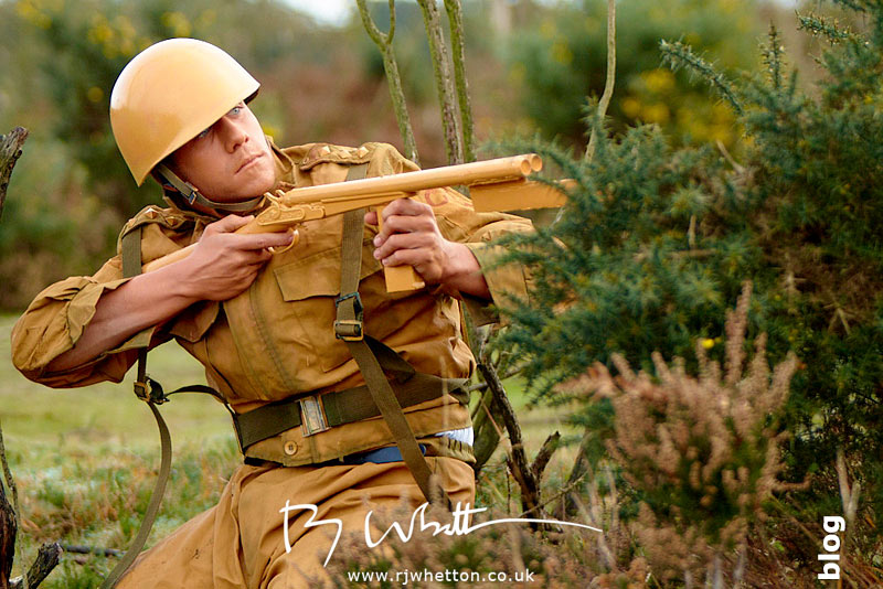 Orange army man shooting at green army - Production Photography Dorset