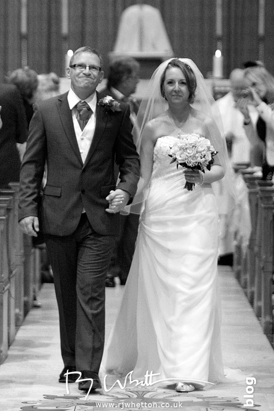 Happy couple exit the church - Professional Wedding Photography Dorset