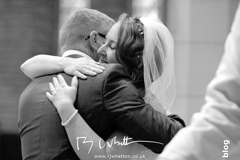 Embrace after the giving of the rings - Professional Wedding Photography Dorset