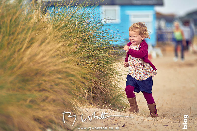 Harper running while playing hide and seek - Portrait Photography Dorset