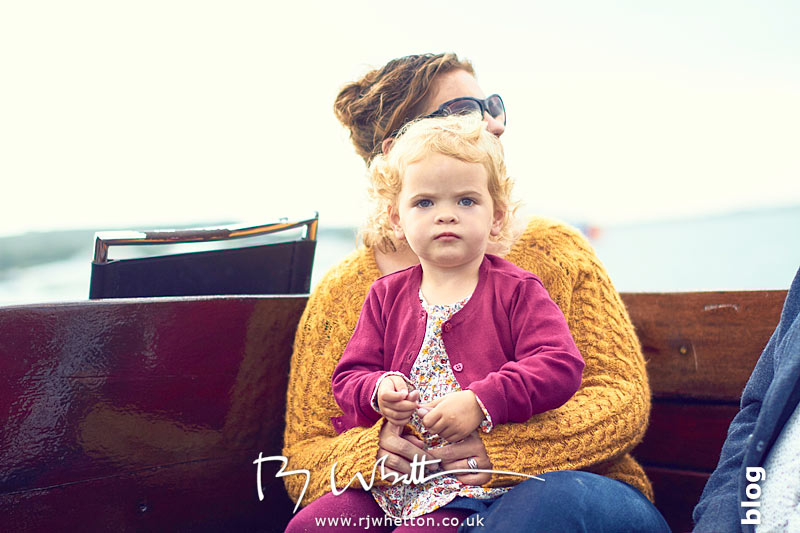 Harper sitting on mums lap in the boat - Portrait Photography Dorset